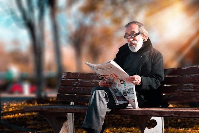 Elderly man reading the paper