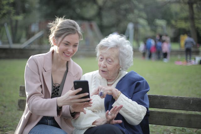 An elderly lady and her granddaughter at the park